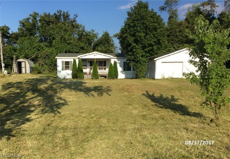 Three bedroom, 2 bath doublewide home on 1.23 acre lot.  Detached 2 car garage.