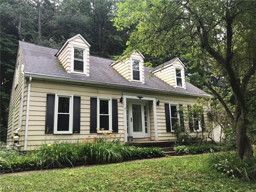 Beautiful Cape Cod on quiet wooded 1.79 acre lot in desirable area of Bath Township. Upstairs there are 3 bedrooms with hardwood floors and 2 updated bathrooms with tile showers. The main floor has a special Family room with hardwood floors, wood-burning fireplace, wooden beams, and a half bath. There is also a large carpeted living room and bedroom/office. The Dining room has an amazing bay window that overlooks the brick patio and ivy-covered hillside. Kitchen has gas stove and full pantry. Fully finished basement w/rec room, additional room, and laundry/work space. Large 2-car attached garage and shed. Many updates including brand new HVAC (2020). Highly sought after location. In Revere school district close to restaurants, shopping, schools, recreation, and freeways. This is a great family home. Must See!!!!