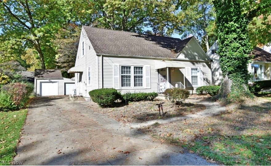 Cute, casual, and ready to call home; this beautifully kept three-bedroom residence packs plenty of style and clean-living space alike! Nestled in a scenic, tree lined lot and surrounded in well-manicured landscaping, it's easy to enjoy great four-season views inside and out from the rear finished sunroom. An oversized detached two car garage gives way to an impressive backyard for outdoor recreation. Through the front door, a brightly painted living room is filled with sunlight from the surrounding windows as plush carpets lead into the nearby formal dining room. The galley style kitchen boasts bold gray cabinets and bright white appliances. Around the corner, built in cabinets separate a pair of first floor bedrooms, each trimmed in hardwood flooring. A full bath joins them with a simple vanity and large shower. Upstairs, the third loft bedroom makes for a fantastic studio layout as more rich hardwood are accented in faux brick work. Newer furnace (2013), hot water heater (2013) and