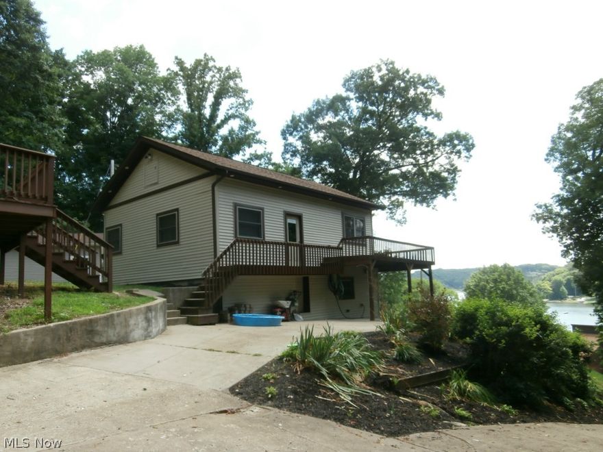 Wonderful lake view in this 3 bedroom home that has been completely remodeled with newer sliding door, roof, tile, laminate floors and windows. Stainless steel appliances stay.. Your family and friends will want to stay over when they have their own guest house. The guest house is one bedroom, living room, kitchen and full bathroom. Newer windows, siding, carpet and deck. Home has a home warranty.  Lake Mohawk is a gated community having a 500 acre lake with unlimited horsepower, three beaches, clubhouse, golf course and tennis courts.  Lake Mohawk is located 45 minutes southeast of Akron & 25 minutes from Canton.  Enjoy fishing year round, swimming, boating, water skiing and more.   One of Ohio's best kept secrets!!