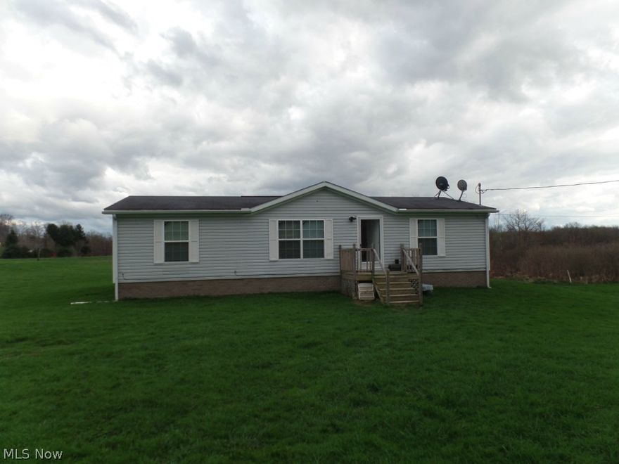 Very neat & clean manufactured home on 3.167 acres on a country road.  Inside area is very open with the kitchen open to the dining room. 3 bedroom, 2 bath, very large closets.  Not far from Garrettsville and SR 422.