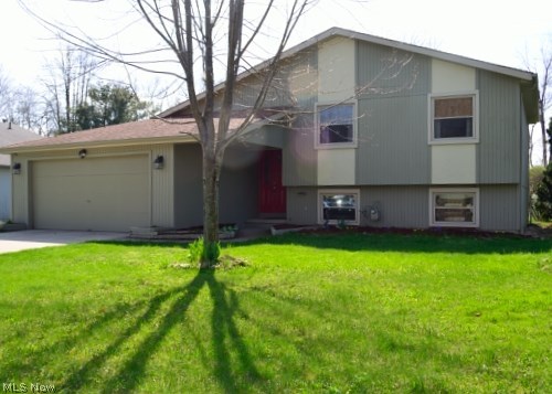 Pride of Ownership... 3 Level Split Contemporary with many updates. The charming front entrance opens to a spacious foyer leading to the Living Room featuring vaulted ceiling and gas fireplace. 3 bedrooms and 1 bathroom on the upper level. On the lower lever is the kitchen with Corian counter-top including all appliances, ceramic tile flooring and modern lighting, dining area, half bath, carpeted family room with walk-out to fenced-in back yard. Laundry room with washer & dryer included. New carpet was installed in April 2015. 2 car attached garage with work-bench. Updates include: windows 2007, Front door, A/C unit and furnace 2010, Ext. paint 2010, Newer roof . This home is a must see on your list, ready to move in! Call today for a private showing!