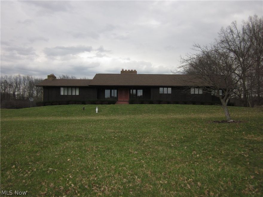 RAISED RANCH features stone wall fireplace.   Vaulted ceilings, 3 fireplaces, spacious bedrooms, 4 car attached garage.  Tons of storage!  Wrap around deck off the back of the house.  Private setting with private pond.