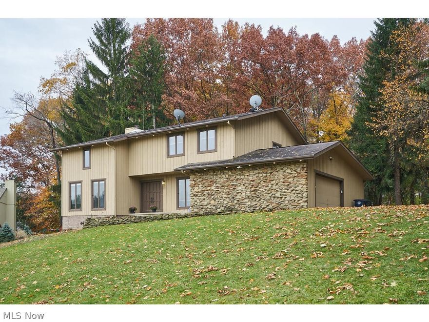 Nature lovers will love this beautiful Merriman Woods home!  This five bedrooms, 4.5 bath home is minutes from the parks and restaurants in the Valley and Highland Square.  The first floor offers a wonderful area to entertain, with an open floor plan between the eat-in kitchen and family room.  The family room has a slider to a spacious deck.  The large living room has huge windows that allow for beautiful metro park views.   The second-floor master suite has 2 walk-in closets, an en-suite bathroom, a wood burning fireplace, and a new private balcony/deck.  There are three additional bedrooms on the second floor and two more full bathrooms. The basement has been finished with another full bathroom, an office, and a large recreation room, complete with a bar for entertaining. The home has a freshly painted interior/exterior and new flooring throughout the home.  The sellers are offering a 1-year home warranty.   You will love all of the wonderful views the Cuyahoga Valley National Park!