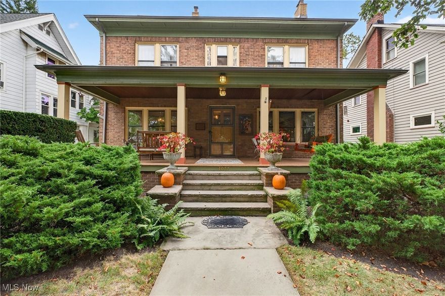 Enjoy Lake Erie breezes at 1077 Erie Cliff Dr., situated 4 homes from the shore with seasonal views on a quiet Cul de Sac in the Cliff Estate's, one of Lakewood's most desired locations, steps from Lakewood Park and schools! This timeless 3-story brick classic colonial offers up to 6 bedrooms, 3 full & 2 half baths with 2 fireplaces and a full finished basement. Graced with a welcoming sandstone walkway leading to the magical expansive front porch, which is a living space in itself, inviting you into the warm and accommodating home with abundant hardwood floors throughout, natural woodwork, crown moldings, built-ins, glass accented doors, crystal knobs and marble surfaces. You will immediately appreciate the energy and spirit of this home. The inviting family room with eleven windows features a cozy wood burning fireplace, while the formal dining room opens with double French glass doors and stunning built-ins & leaded glass doors. A swinging door leads to the kitchen with Cherry Cabinets and a breakfast nook & Bay Window that looks out to the spectacular private backyard with a pergola, fertile gardens & 2 separate patios. 4 bedrooms on the 2nd floor including the primary bedroom with 7 full windows and a Murphy Bed nook, a full bath, a Jack & Jill bath, all  bedrooms with ceiling fans. The North rear bedroom has a walkout 2nd story balcony with views to the famous Lakewood Fireworks and lush shaded backyard! The 3rd story offers an additional full bath, bedroom and large bonus room with a large Cedar closet just outside in the hallway. The finished lower level offers a 2nd gas fireplace in the entertaining area, half bath, functional laundry room full of cabinetry, a project area with workbench and 2 additional spaces for storage or canning rooms!