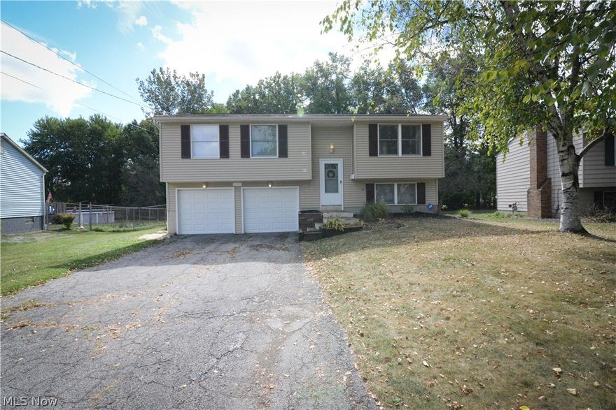 Awesome Austintown BiLevel home! This one has a nice spacious living room. The kitchen has great cabinet and counter space. Great dining area off the kitchen with slider doors overlooking the Multi tier deck and backyard! The bedrooms are spacious and have nice closet space. Updated interior doors in most of the home, as well. Modern bath with updated tub shower surround and new toilet. The lower level was just remodeled and has new laminate flooring, an office nook, and a remodeled half bath. Laundry/utility combo in lower level as well. Attached two car garage, auto door opener, keypad. The deck is great and gives you so much room for entertaining in your fenced back yard. Central Air. Siding, roof and furnace updated in 2008. Water tank new 2015. Alarm system. Nice neutral color tones in the living spaces, this is one you will want to come and check out soon! Call now!