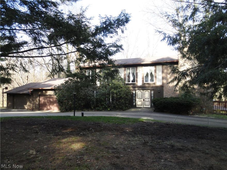 This lovely home is situated on 2 acres where peace and serenity abound! A very unique floor plan where every room is very spacious and includes windows which extend from floor to ceiling allowing the sunlight to flood the rooms! It's impressive to step into the 2 story foyer which leads to the 25 x 15 living room with stone fireplace and windows across the back. There's also a first floor formal dining room, eat in kitchen, half bath and a family room. The rooms are all painted in a nice neutral color with neutral carpet too. Large screened porch and two balconies overlook the big back yard with woods across the back. Some updates in the 3 bathrooms, new windows in 2001, furnace in 2010,roof in 2000. The lower level has two rec rooms with another fireplace, 3 car garage. Ready for your updates to make this your own!