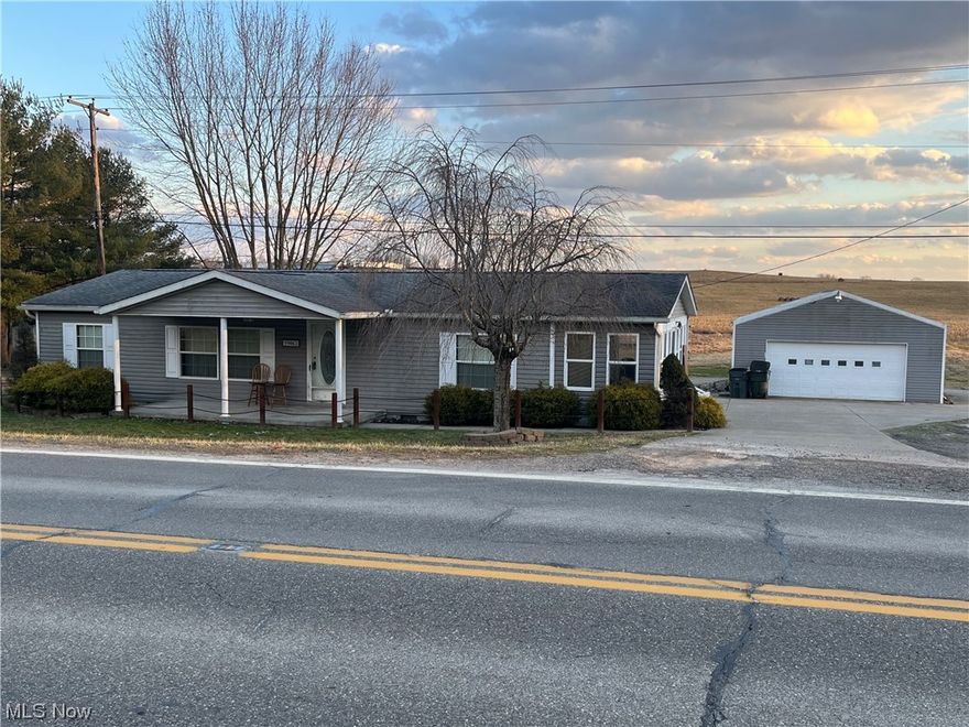 Step into comfort and luxury with this stunning 3-bedroom, 2-bath manufactured home nestled on a serene 2-acre lot. Perfectly situated at the edge of town, you'll enjoy the tranquility of country living with the convenience of urban amenities just moments away. As you enter, be greeted by the grandeur of vaulted ceilings that elevate the spaciousness of the living areas. The heart of the home boasts beautiful oak kitchen cabinets complemented by a stylish island breakfast bar, creating the perfect setting for culinary delights and casual dining. Relax and unwind in the luxurious master bedroom featuring an ensuite bathroom complete with a soothing garden tub, offering a private oasis to escape the hustle and bustle of everyday life. Entertain guests or simply soak in the picturesque surroundings from the comfort of your enclosed porch. Step outside onto the inviting front porch and embrace the fresh air as you sip your morning coffee or bask in the golden hues of sunset. With ample space for your vehicles and storage needs, the 2-car detached garage ensures convenience and organization, while the paved circular driveway adds a touch of convenience to your property. Don't miss this opportunity to experience the perfect blend of comfort, style, and tranquility. Schedule your viewing today and make this dream home yours!