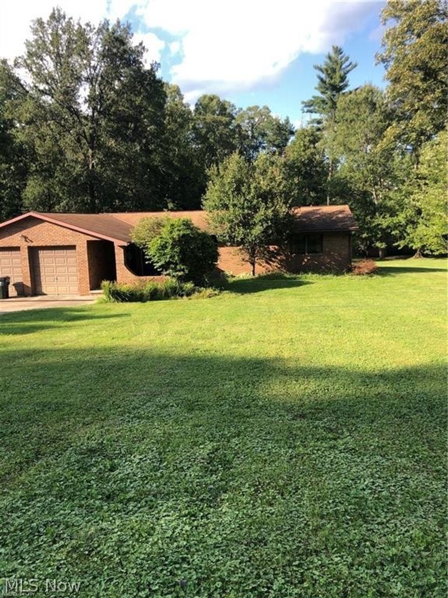 Well built SOLID BRICK home in desirable neighborhood within minutes from State Route 60.  This home sits on two beautiful lots equaling 1.67 Acres of land to enjoy year round.  Exiting from cul-de-sac on the  cement driveway with extra parking pad.  Home also has a 2 car garage and deck on back of home overlooking wooded area. The dead- end street on the cul-de-sac lends itself to low traffic.  Walking through the front door you will find the Living room with large front window to allow extra light, the kitchen is equipped with an abundance of cabinets, gas range, refrigerator and dishwasher.  A large dining area could seat 8-10 and a  separate room off kitchen could be for multiple uses; den, TV room, sunroom, office, (the choice is yours).   Split bedroom plan with master and master bath on one end and 2 bedrooms and bath on other.  Upstairs laundry area has hookup for washer, the downstairs area is washer and dryer, Large family room with unique brick fireplace, extra storage room,