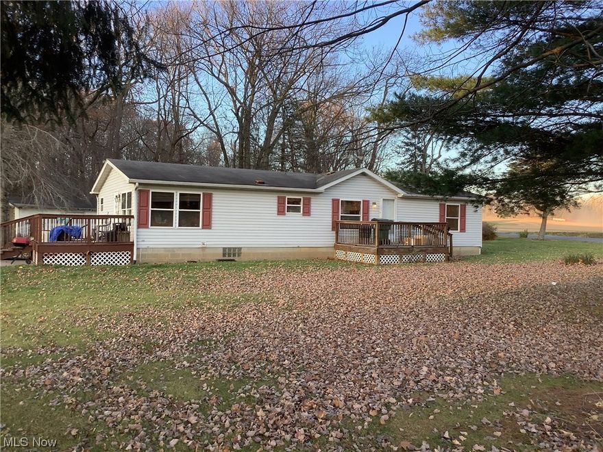1999 Modular home built ona full basement with a block foundation.  3 bedroom, 2 full bathrooms including a huge master bath.  There is a wood burning stove in the basement and a bar area.  The pool table stays!   
Outside, there is over 8 acres of land with a huge garage.  There are 2 decks, one off the front of the house and one off the side.  There is also a large poured concrete area for parking cars.  
A new propane furnace was installed in Oct. 2022, and a new water pump was installed by the shed in 2021.
