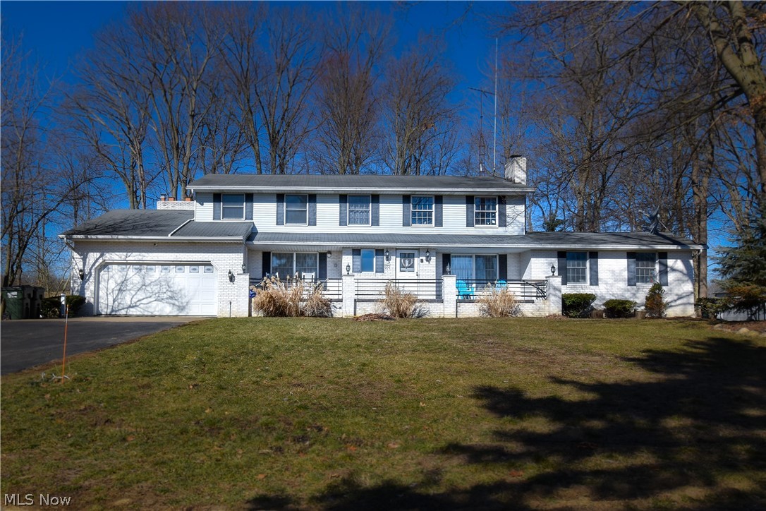 Hurry in to see this incredible opportunity to own this beautiful home on almost 5 acres in Jackson Twp. You will love watching the sunrise and sunset from your front and back porches over your sprawling land. Partially wooded parcel sits far off the road providing a park like setting with privacy and seclusion. This updated home has been converted to a single family home from a duplex and could be converted back if desired. The home has 4 spacious bedrooms, 2 walk-in closets, 3 full baths, 2 half baths and 3 fireplaces. The completely updated walkout lower level would make a great man cave, media room, game room, large office, or additional living space. The options are endless. What would you do with the 3 car attached garages and 5 car detached garage? The 8x12 shed in the back has a rubber floor and would be nice for a small hobby farm or extra storage. For added safety a 8 x 6 EF5 rated FEMA compliant above ground steel tornado shelter has been added outside of home. Please