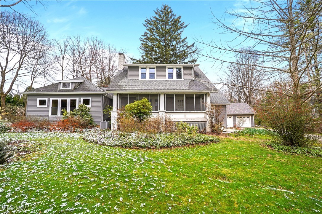 Welcome to this wonderful 4 bedroom, 2 bath century style farmhouse nestled on 1.5 wooded acres in the heart of Bath Twp. Two sizeable additions (kitchen, owners suite & laundry) lend to the desirable layout and convenience of first floor living. Expansive kitchen offers all appliances, maple cabinetry, granite, and tile floor. Separate eating area features a full wall built-in pantry, double closet, access to the deck, and arched entries to the formal living and dining rooms w/crown molding. Formal living room boasts brick wood burning fireplace, hardwood floors, and front door entry from screened in porch w/wood ceiling and floors. Engaging family room with glass French door to small office/den with built-in bookshelves. Adjacent first floor master presents numerous windows, overhead and sconce lighting, and 2 closets (one is walk-in). Nearby luxurious full bath highlights vaulted ceiling, skylight, walk-in shower, double sink vanity w/granite, and linen cabinet. First floor laundry w/two access entries features a utility sink, white cabinetry, granite, folding counter and completes the first level. The second floor offers the three remaining bedrooms and full bath. Recessed lights throughout first floor. Notable improvements include vinyl siding, windows, doors, updated electric panel (one of 2 panels), roof 2011, septic 2001, concrete drive w/extra parking pad, stamped concrete, and rear composite deck w/built in bench seating and planters. Full basement (newer side is part of additions) Two newer furnaces. 2.5 car det. garage. Award winning Revere schools.