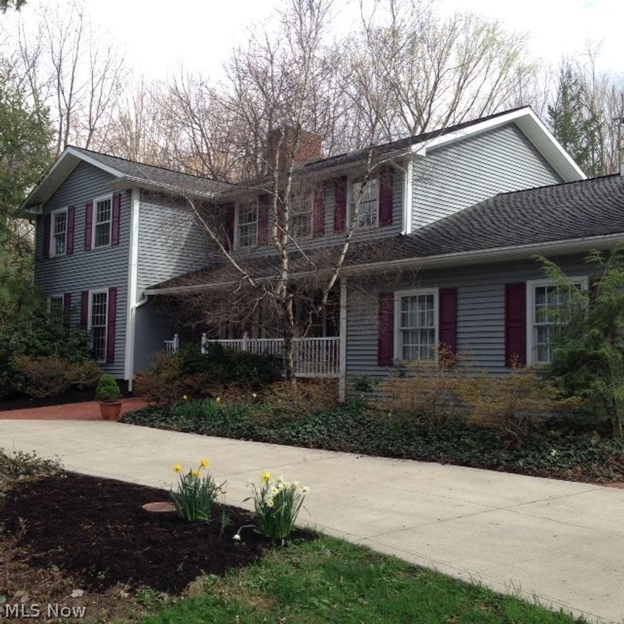 One of a kind, 4 bedroom, 4 bath colonial on 2 ½ acre wooded lot.   Hardwood floors and granite countertops along with many built-in cabinets throughout. Newer kitchen ideal for aspiring chef. State of the art stainless steel appliances -- large island perfect for entertaining.  Cherry cabinets and desk area make the kitchen unique.   Eating area has wet bar, fireplace and windows to enjoy landscaped courtyard.   Formal dining room has great wood moldings with easy access to kitchen.  Additional fireplace in family room with custom built-ins and beamed ceilings.  First floor library offers built-in bookcase and fireplace -- outstanding location for office/den.   Second level has hardwood floors and a larger master bedroom with private bath/whirlpool tub/walk-in shower/walk-in closet.  Three additional bedrooms, one with private bath.  Dormer provides more storage or expansion possibilities.  Two car attached garage.  Outbuilding has three car garage, barn and three season room with sto