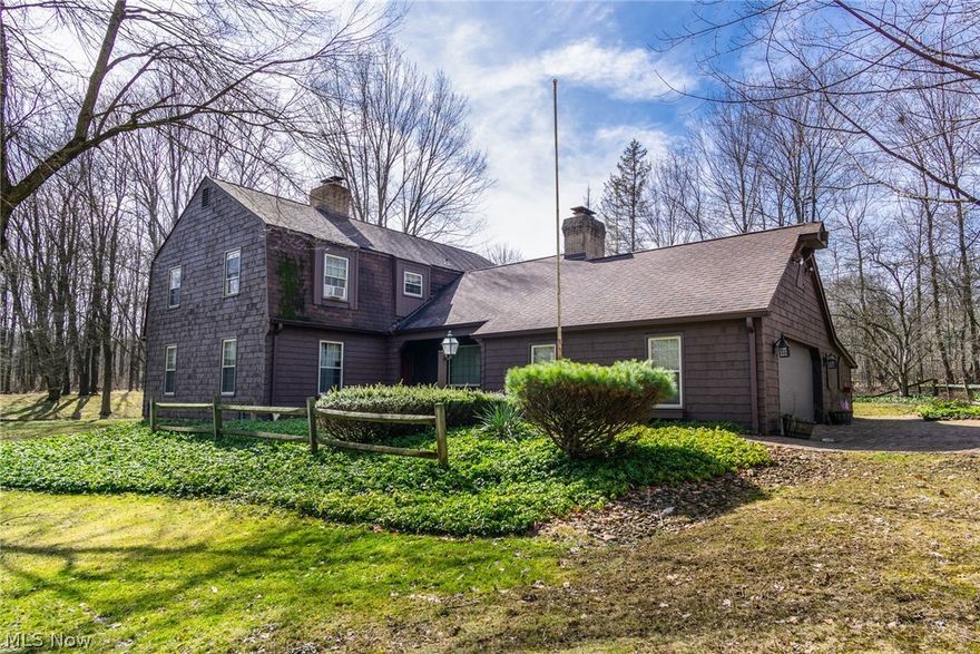 This unique home offers highly personalized old-world style, with a rustic touch. The outward design with attached two car garage, creates a walkway towards a main side entrance at the kitchen, as well as having a formal entry way at the front of the home. The kitchen is rich with wood covered walls. Exposed truss styled ceilings show a theme that is carried throughout. Tiled floor compliments the brick backsplash that winds below the cabinet work. Next to the kitchen, a formal dining area opens with multiple tiers of lighting and large framed windows. The living room boasts carpeted floors along with a wood and brick trimmed fireplace. A slate tiled foyer finds the main entrance way, along with entrances to the second-floor staircase, a first-floor half bath and one of two entrances to the great room. The great room offers an additional fireplace with rich brick and stonework. Upstairs you’ll find the main bedrooms lining a carpeted hallway. Each of these rooms are filled with elegant