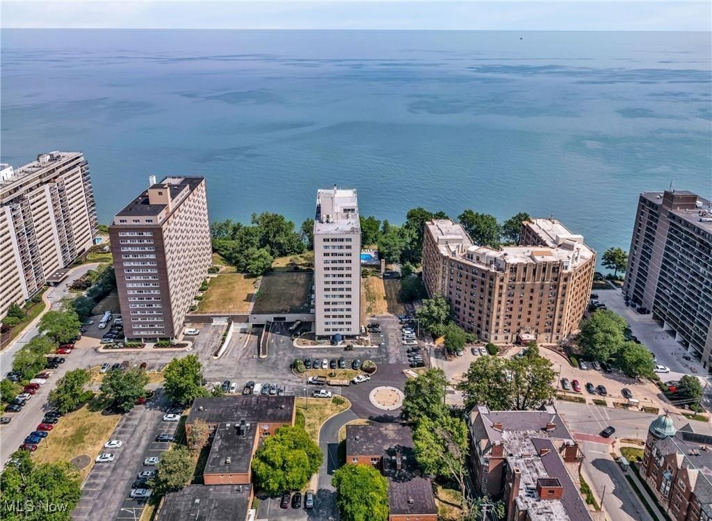 Come home to stunning views of Lake Erie and Downtown Cleveland in this beautifully renovated one-bedroom condo on the Gold Coast! Spacious and move-in ready, this unit stands out with its open-concept layout and expansive windows that flood the space with natural light—and offer a front-row seat to the sparkling downtown skyline, especially breathtaking at night. The kitchen is a chef’s dream—featuring modern gray cabinetry, light countertops, a generous island, and white appliances (all included). A unique hallway with a decorative mantle offers additional storage and more lake views. The oversized bedroom is bright and airy, complete with easy-lift blinds and large closets. The updated full bath features a sleek walk-in shower with glass doors. Renovated from top to bottom in 2021, the unit also includes brand-new electrical wiring and a new panel—an important and valuable upgrade. Every detail has been thoughtfully considered, and the flexible layout allows you to make the space your own. Convenient laundry rooms are located on every floor, and a storage locker is included. Enjoy fantastic building amenities including a rooftop deck, outdoor pool, party room, picnic area, and a rentable guest suite on the lobby level. Pets are welcome (up to 50 lbs), and there's even a dog park. Ample free outdoor parking is available, or opt for indoor garage parking for just $50/month. Rentals are permitted, with similar one-bedroom units leasing for $1,500– $1,900/month. The building is currently undergoing major upgrades to restore its full potential. Come see this stylish home!