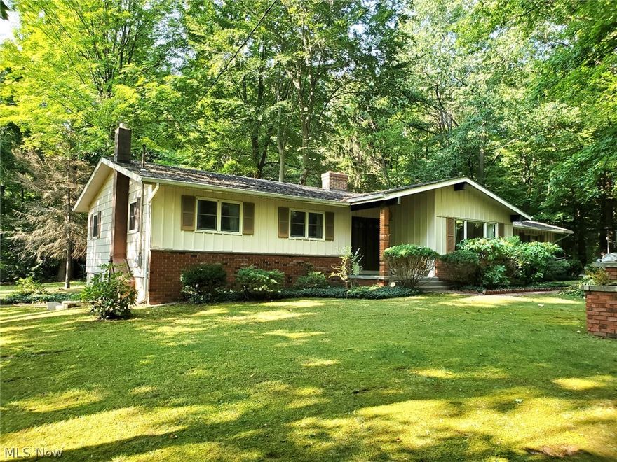 One of the prettiest lots in Northern Mantua is the setting for this 3 bedroom 1.5 bath ranch with full walkout basement, two car attached garage and an extra 24x24 storage building for boats, lawn equipment, atvs, etc. The house features a vaulted ceiling in the living room with a floor to ceiling double sided brick fireplace. Sliding glass door from dining room will lead you outside where you’ll find a large deck with outdoor fireplace, brick patio/walkways as well as a carport off the driveway. The yard features large trees, ivy, myrtle and hostas. Conveniently located west of SR44, not far from SR422.