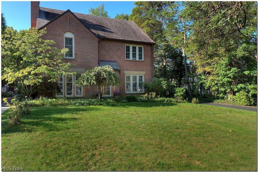 Outstanding center hall brick colonial exuding many qualities of classic Shaker Heights architecture. From the enchanting leaded glass windows to the intricate brick and sandstone work and slate roofing, this home does not disappoint! A tiled floor entry greets you at the front door leading to a hallway of hardwood floors that flow throughout most of the home. A gracious Living Room with floor to ceiling windows, coved ceilings and fireplace. Across the hall is the Entertaining sized Dining Room, leading to the open and spacious Eat In Kitchen. There is a lot of cabinetry, countertops, all appliances and access to the back yard. Off the back hallway is the 2 car attached garage, Half Lav and the cozy wood paneled Library. An office area is also conveniently located off the Library leading to the back yard patio. The 2nd floor has two Bedrooms that share a Jack n Jill full Bathroom, the Master Suite with a dressing room and Full Bathroom. At the rear of the 2nd floor is the fourth Bedro