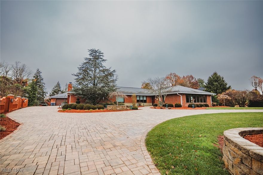 Exceptional 3,826 sq. ft. ranch luxury home offering luxury finishes, multiple living areas, and a beautifully flexible floorplan. A circular driveway welcomes guests to the front entrance, with an additional long private driveway leading to the attached garage. Inside, the home features all hardwood flooring, a spacious living room, and a large bar area with a gas fireplace, family room seating, and space for six barstools, as well as additional dining space.

The gourmet kitchen showcases custom cabinetry, a Sub-Zero cabinet-front refrigerator, a Dacor oven with warming drawer, a gas cooktop on the island, a Wolf microwave, a wine chiller, and pull-out bread storage. A large window overlooks the pool, and a high-tech electronic pet door adds convenience. An adjoining flex area with custom built-ins serves as an office or generous eat-in space.

The bedroom wing includes two large bedrooms with double closets and a cedar-lined hallway closet. The owner’s suite (14x25) offers recessed lighting, Pella windows, double closets, and a luxury smart toilet. The ensuite bath features a large walk-in shower, pocket door, custom cabinetry, and its own Rinnai tankless water heater.

A standout feature is the 22x30 heated and cooled garage with paved floors, full kitchen, floor drains, and utility sink—ideal for hobbies, entertaining, or guest use. Outside, enjoy a saltwater heated pool with stainless-steel sides and a 3’ to 9’ depth range. The property also includes two Generac systems (20kW & 24kW) for whole-house backup power.

This rare ranch offers exceptional quality, space, and versatility all on one level—truly a must-see.