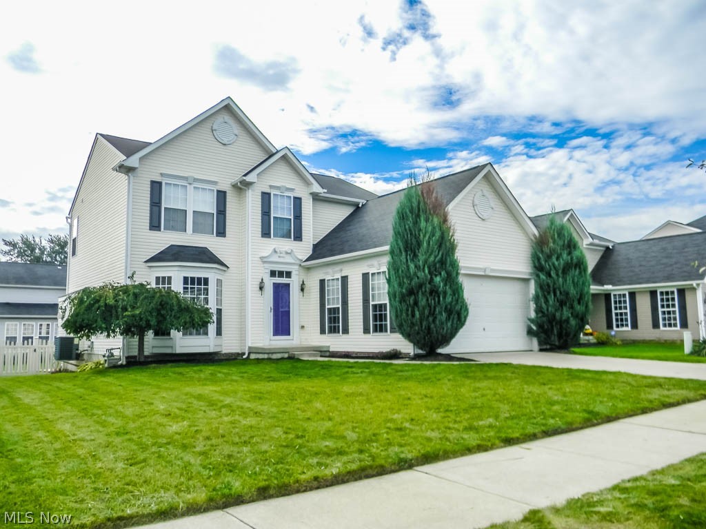 Upon entering this wonderful colonial you are welcomed by timeless hardwood floors, 9 foot ceilings throughout and a spacious open floor concept. Immediately off the right of the entryway is the great room featuring a lovely bay window overlooking the front yard. Opposite is the formal dining room complete with floor to ceiling windows, chair rails and crown molding. There is also a first floor half bath conveniently located in the center hallway. At the heart of this home, you'll find a large eat-in kitchen boasting stainless appliances, extra tall cabinets, an island, a breakfast bar and a pantry - there is no shortage of counter or storage space here! The kitchen opens directly into the oversized living room, which showcases a stonewall fireplace and an entire wall of windows facing south, as does the charming sun room also just off the kitchen, allowing the home to overflow with natural lighting. Through sliding glass doors the sun room leads directly to an attached deck that steps