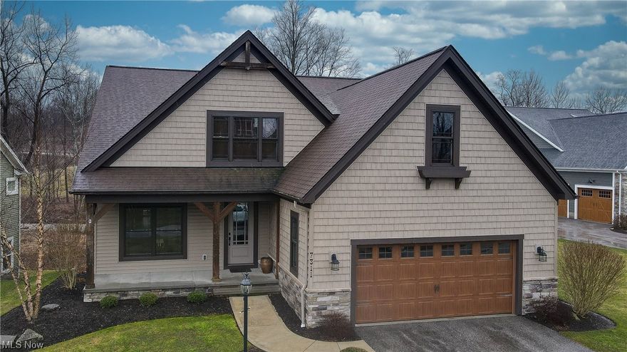 Amazing custom built cluster home by Payne and Payne in 2014 with many upgrades & extras! Open entry with soaring ceilings, tall windows and doorways & hardwood floors thruout. Private office or living room that leads to spacious gourmet kitchen highlighted by the oversized island with breakfast bar seating; custom cabinetry and wonderful counter space and stainless appliances. The spacious 2 story great room with stone front fireplace & wall of windows opens to the dining area and is perfect for entertaining. Step out to the private screened porch that connects to the additional open deck providing months of outdoor enjoyment and overlooking the scenic backyard wooded setting complete with a charming bridge and babbling creek running through it. First floor master suite with soaking tub and tiled walk in shower; double sink vanity and spacious walk in closet. The first floor is complete with back hall mudroom off the oversized 2 car garage; separate laundry room with built ins and powder room. Walk up to the second floor with open loft area and 3 generous size bedrooms with large walk in closets and 2nd full bathroom. Additional large recreation room in the walk out lower level with full sunlight windows & walkout to the patio below. Plenty of storage space and plumbed for an additional bath. Excellent location in Canyon Lakes with plenty of scenic walking trails and easy access to highways, shopping and into Chagrin Falls. Desirable maintenance free living at it's best!