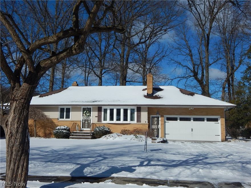 Handsome 3 bedoorm 1.5 Bath Brick/Vinyl Ranch enjoys privacy on a No Outlet Street. Set among winding roads and Mature trees. Freshly painted spacious Kitchen has Solid surface Corian tops, & sink, gorgeous all Wood Cabinetry, Refrigerator, Stove & Microwave stays.  1/2 bath in hall. Living Room features a gorgeous Bay window, Gas Stone Fireplace, & hardwood under carpeting. Spacious Formal Dining room has a wide, glass, built in buffet for all your treasures. 3 Nice sized bedrooms. Full bath has original, pristine tile. The 4 season, heated, Sunroom has 4 picture windows to take in gorgeous views of the yard. Door leads to cozy deck & onto a generous sized, circular, paver stone patio with piped Gas grill, all framed by extensive landscaping & custom fencing. New driveway 3 yrs, Furnace & AC 2021 Updated windows, New garage door & opener. Basement features a Rec Room with a brick, woodburning fireplace and lots of built in furniture. So great for that Man cave or space for the Kiddos!