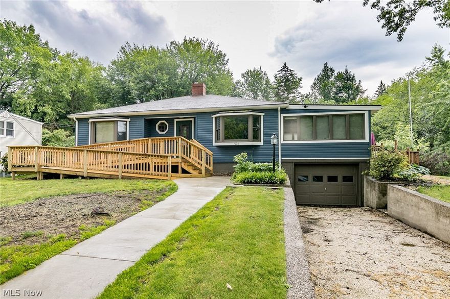 This Kent, Ohio 3 (possible 4) bedroom Ranch--a stone's throw from Longcoy Elementary School-- with newer siding (2018), newer kitchen cupboards, vinyl replacement windows, Original Hardwood UNDER carpet in SPACIOUS living room (& 2 bedrooms), sunroom w/ double-hung windows & newer entry doors is ready for YOUR personal touches! Generous lower level family room and basement bonus room (was used as bedroom 4 by current owner) w/ adjacent half bath (and a utility shower near laundry). Bathtub professionally restored w/ 10 year warranty. Ramp in front was added in 2018! Great backyard and wrap-around deck. A comfortable walk to Fred Fuller Park & the newly revitalized downtown Kent, it's also handy to shopping, restaurants, etc. in the Stow-Kent area!  Aside from improvements that have already been handled for the lucky buyer, the house is being sold by the family as is. Make this house your home... See it soon!