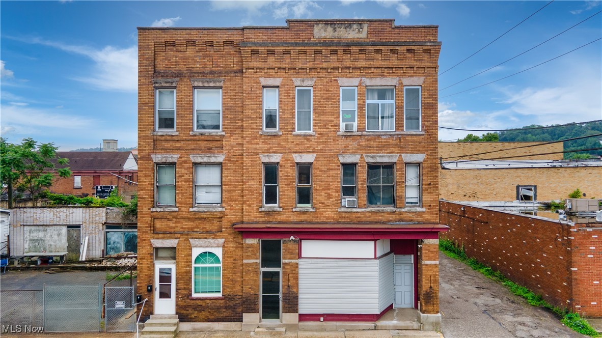 Take a look at this excellent investment opportunity in the heart of downtown Steubenville! This fully occupied commercial apartment building is ideally located just 6 minutes from Franciscan University and a short 8-minute drive to Weirton. The property includes 10 rental units—8 one-bedroom, one-bath apartments currently leased at $750 per month, and 2 units featuring an open layout with combined kitchen, bedroom, and bathroom leased for $650 a month. The building generates a net monthly income of approximately $5,000, with strong potential for increased revenue through rent adjustments or future improvements. Updates have been made, including newer doors and vinyl showers in 2020. In 2019, a structural wall was installed near the rear basement entrance, along with new cement work and a chain-link fence. A newly constructed wooden staircase, built in 2024, provides exterior access at the back of the building. The first floor is currently used for storage and also includes a bedroom with a full bathroom, offering additional flexibility or rental potential.