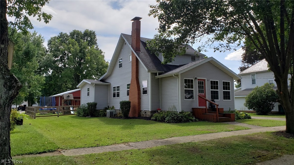 Enjoy the small town community home with 3 br 2 bath - full basement - many updates! Custom painting - newer updates to kitchen - ceramic floors that lead into the dining room as well - plenty of natural sunlight - a master bedroom and full bath conveniently located on main floor. The living room boost so much character with beautiful BAMBOO wood floors built in book shelves and the brick fireplace - open wood spindle staircase - and an adjoining closed in front porch. 2 additional br with lots of closet space upstairs and full bath - a full basement with additional heat source - ready to make additional living space! HOT TUB -fenced back yard - everything here! Excited to share that this home has a new HUGE detached garage that is immaculate - insulated - heated - cemented - high doors - for all your needs! In addition another 1 car detached garage and a 1 vehicle carport in back and a 1 vehicle carport in front. You must see it!