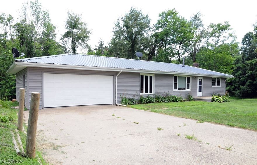 Sitting on 2 acres, this  3 bedroom,  1 bath ranch  home has a metal roof, newer windows, hardwood floors, is ready for occupancy.  Also has a wood stove as well as electric baseboard heat.