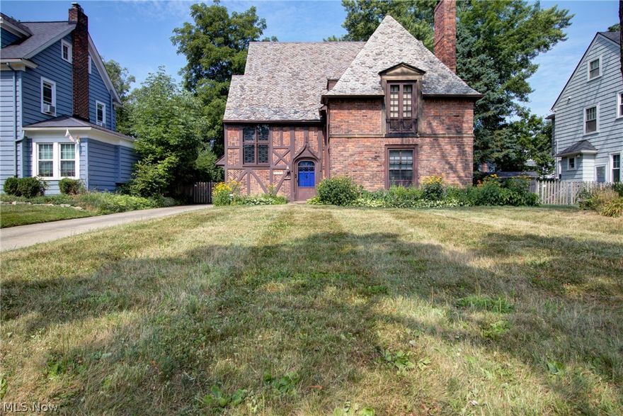 Located in the Fernway Neighborhood of Shaker Heights, this exceptional English Tudor was masterfully constructed with amazing detail, both inside and out. The trademark features are in pristine condition including the original slate roof, stationary leaded glass windows, hardwood floors, wooden windows with sashes, French doors and baths with intricately tiled floors. The warm tones of the original woodwork with 8-panel doors and moldings, arched entry and doorways, a pedestal sink and an antique vanity are more of the special features. Beautiful hardwood floors are present on all three levels. The first level includes a very spacious living room with a stone fireplace detailed with a herringbone-patterned firebox, a large dining room with French doors leading to the back patio as well as a bright and airy kitchen with a mosaic-tiled garden window, plenty of countertop and cabinet space and a commercial grade range and hood.  The second floor has three bedrooms with an abundance of closet/storage space and though the third floor could be used as a library, office space, or perhaps a teen suite, it is essentially a second master suite with a full bath and walk-in closet, just as the master suite is on the second level. Many of the walk-in closets are recently outfitted with new shelving. The two remaining bedrooms are adjoined by a Jack and Jill bath. The 2.5 car garage has a new garage door & the bsmt area has plenty of headroom for a workout space or could easily be finished. While you'll enjoy having the clean, radiant heat, this home has ductless mini split units for the air conditioning, as well. There have been numerous upgrades mechanically & aesthetically including an attic window, roofing repair/tune-up, plumbing, window well repairs, all new lighting, custom window treatments, fresh paint & many others. Nearby amenities include the Van Aken District, rapid transit, Cleveland Clinic 15 minutes away & Case Western Reserve 10 minutes away.