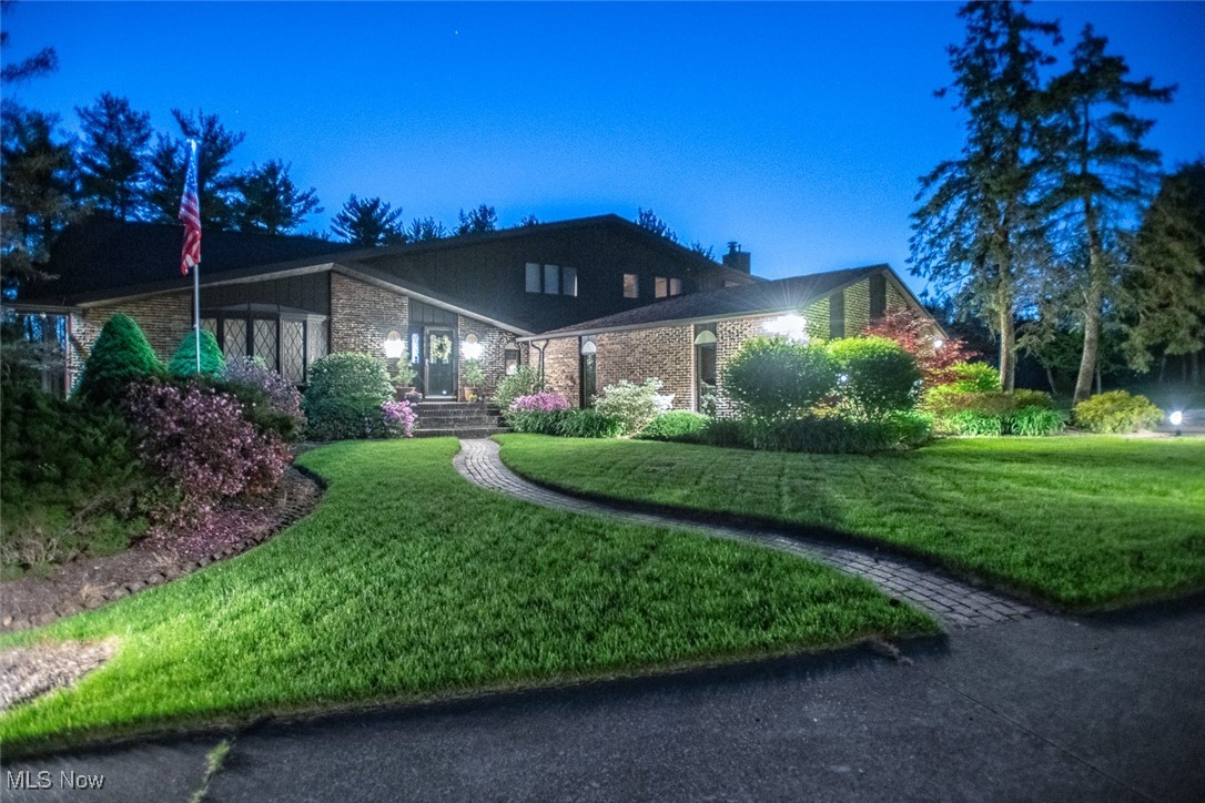 Tucked away on two serene, park-like acres with its own private pond, this custom-built home offers a rare combination of space, comfort, and functionality—inside and out. A 36’x30’ heated outbuilding with electricity provides the perfect space for a workshop, car collection, or creative pursuits. Inside, you’ll find thoughtful updates throughout, including a vaulted living and dining area with a bay window, fresh carpet, and updated paint. The remodeled kitchen features quartz countertops, a generous island with breakfast seating, soft-close cabinetry, and stainless steel appliances, flowing seamlessly into a cozy eating area and screened-in porch for effortless indoor-outdoor living. The adjacent family room showcases a striking stone fireplace flanked by built-ins, plus a wet bar ideal for entertaining. A private study with another fireplace and built-ins leads through French doors to a library retreat. Additional living spaces include a spacious sunroom with deck access and a spiral staircase to a wine room, as well as a large laundry area and half bath on the main floor. Upstairs, the expansive owner’s suite offers its own fireplace, sitting area, private balcony, walk-in closet, and a luxurious en-suite bath with dual vanities. Four more bedrooms and two full baths complete the upper level. The walk-out lower level adds even more versatility, with a recreation space, second kitchen area, full bath, wine room, and access to a covered patio. A private greenhouse adds to the charm of the property, and with easy access to highways and shopping, this one-of-a-kind home truly has it all.