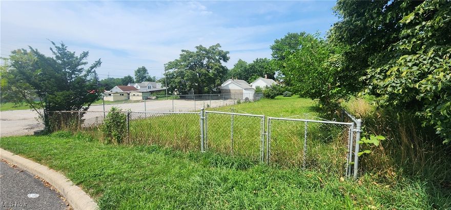 Garfield Heights residential buildable lot for sale to build home.  Currently 3 sides of lot is fenced in this is to the right of gravel parking lot and their are large train car wheels to the left of the property.