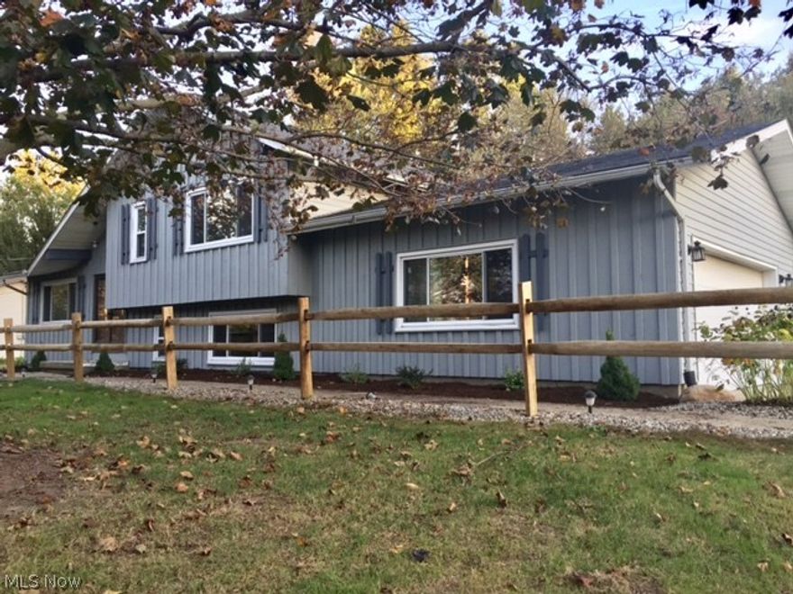 Updated 3 bedroom, 2 full bath turn-key home located in Rootstown Township. Over 2,000 sqft of finished living area. This home sits on almost half an acre! Stainless steel appliances, new pergo flooring, carpet and paint. New stainless steel refrigerator and stove. The sliding glass door right off of the dining room offers a ton of natural light and provides easy access to the beautiful/private backyard. Over-sized 2 car attached garage, open-concept layout, office on the lower level and finished rec room in the basement! Come see for yourself what this move-in-ready home has to offer!