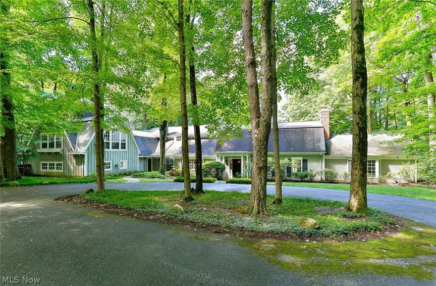 This property boasts one of the most scenic and breathtaking views of the Chagrin Valley! Original house was a converted barn, now a soaring beamed ceiling 2 story great room with fireplace and hardwood flooring. 1st floor master bedroom with unique outdoor stone shower along w full master bathroom and walk in closet. Additional 1st floor guest bed and bath, library/office w built in bookcases and private bath; extensive back hall mudroom/laundry and half bath. Formal dining room opens to sunroom with more windows overlooking the valley. First addition was designed by Tony Pascevitch and built by Pistone and Tesauro builders, includes updated kitchen with spacious counters and breakfast bar opening to large family room with dramatic stone fireplace and walls of windows and French doors opening to amazing views of the Chagrin Valley! 2nd floor w unique architectural child dream bedroom designed by Richard Kawalek and built by Yoder Construction w built in tree fort (featured on Home and