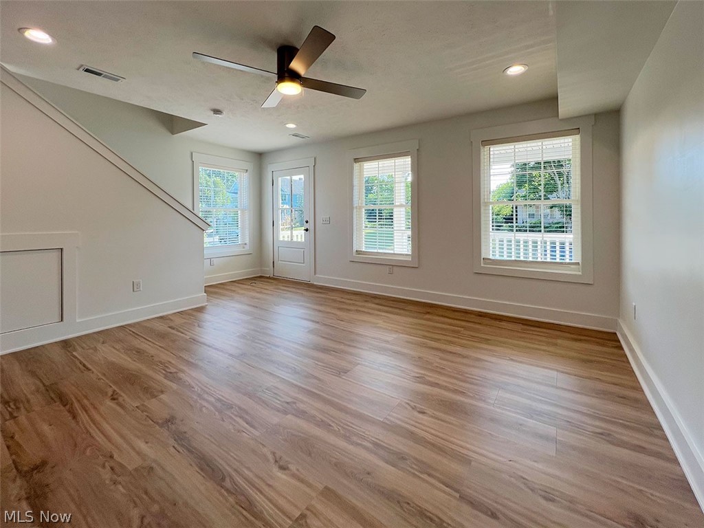 Front doorway to property with a covered porch and board and batten siding