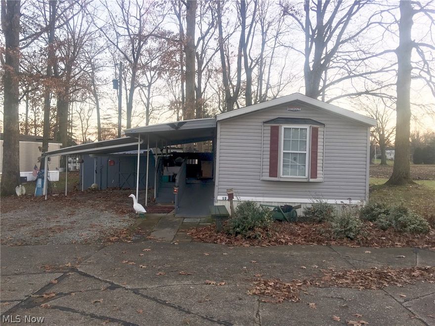 Opportunity and Location Awaits! This one owner Schult manufactured home offers plenty of space and privacy out off the back deck and views of open field for relaxing in the evenings.  Carport covers front deck with wheelchair ramp and also one parking space.  16 X 20 shed stays with the property.  For added protection, this home offers a generator. New shingles in 2017.  Indoor water supply line installed in April 2014.  As you enter, you will find a spacious living room, and a large eat-in kitchen with built-ins. Refrigerator, Dishwasher, Range, Washer and Dryer all stay.  Buyer must get park approval. Lot rent of $310/month plus water, sewer and trash fee paid to park.  Buyer to verify room measurements.