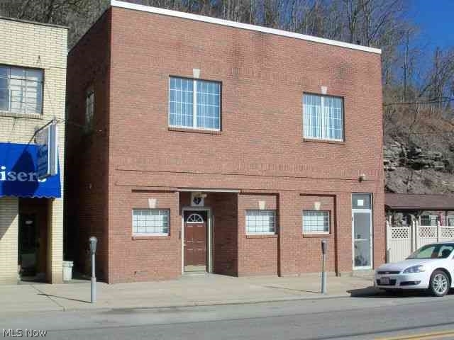 Solid building, new brick front, upgraded electric, new water lines, some new windows, 4 upstairs office with 1/2 bath, low utilities, ample parking.