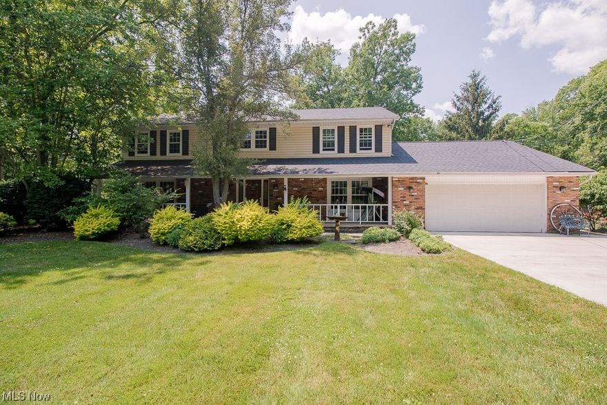 This home offers all the privacy and acres in the heart of Lake County. It is situated on six plus acres and sits 400 feet off the road tucked between two homes. This center hall colonial features 4 bedrooms, 3 full, 1 half baths. The large eat in kitchen has new appliances, granite countertops and sliding doors to the backyard. The family room/great room has wood floors, large brick fireplace and wet bar for entertaining. The dining is situated off the great room with beautiful French doors separating the rooms. The primary bedroom offers a large 6 x 9 walk in closet, linen closet, double sinks and jacuzzi tub. Three additional bedrooms have large walk-in closets. The basement provides ample space for a workshop on one side and recreation room on the other with a nature stone floor. In addition to the 2-car garage, you will find an additional 24 x 30 outbuilding large enough to hold 3 cars with heat and water with a dedicated driveway plus a barn with two horse stalls attached to the outbuilding. Newer roof, windows and siding. The 17th hole of Little Mountain Country Club is across the street from the driveway. There is enough land to build to the right or the left of the driveway.