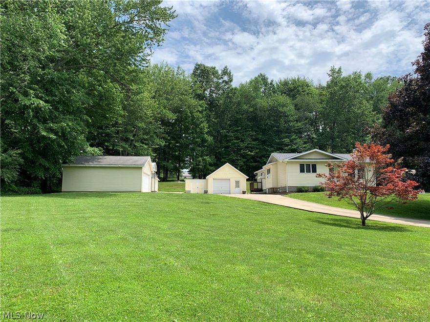 Portage Lakes area!!!  1.44 acres! Last house on dead end street. Lots of storage space. Detached 2 car garage and 1 car garage. Tall carport, storage barn type shed.  Park like backyard with firepit, hammock, zipline, picnic table.  Large kitchen with tons of cabinets and drawers. Pull out drawers. Spacious open living area with fireplace. Full bath and bedroom in lower level.  NEW roof in May 2021.  Screened in back porch. Lots of great features on this property. All offers to be submitted by 12 noon. June 16.