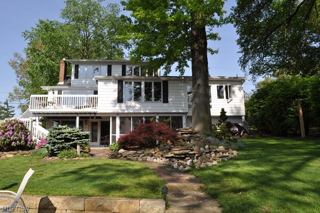 Gorgeous lake front on main chain of lakes with 3 bedrooms, 3.5 bath & approx. 3149SF including finished walk out* Upon entry, foyer leads to vaulted great room & formal dining room with gas log fireplace, bright and light with sky lights & window wall overlooking lake & access to deck* Gourmet vaulted eat in kitchen with granite counter top, stainless appliances (refrig, range, dishwasher & microwave), ceramic floor, sky lights & window wall overlooking the lake* Spacious 1st floor master with wood burning fireplace, walk in closet, glamour bath & 1st floor laundry* 2nd level vaulted guest suite with sky lights, walk in closet, window wall & full bath with sky light* Walk out lower level with huge rec room, wood burning fireplace, small kitchenette, bedroom & full bath* Rec room opens to screen porch & covered patio* 2 car attached garage* Beautifully landscaped with water fall* Updated sea wall & patio* Other updates since 2007 include addition to great room, furnace, central air, ho