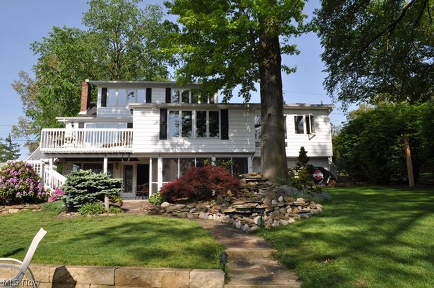 Gorgeous lake front on main chain of lakes with 3 bedrooms, 3.5 bath & approx. 3149SF including finished walk out* Upon entry, foyer leads to vaulted great room & formal dining room with gas log fireplace, bright and light with sky lights & window wall overlooking lake & access to deck* Gourmet vaulted eat in kitchen with granite counter top, stainless appliances (refrig, range, dishwasher & microwave), ceramic floor, sky lights & window wall overlooking the lake* Spacious 1st floor master with wood burning fireplace, walk in closet, glamour bath & 1st floor laundry* 2nd level vaulted guest suite with sky lights, walk in closet, window wall & full bath with sky light* Walk out lower level with huge rec room, wood burning fireplace, small kitchenette, bedroom & full bath* Rec room opens to screen porch & covered patio* 2 car attached garage* Beautifully landscaped with water fall* Updated sea wall & patio* Other updates since 2007 include addition to great room, furnace, central air, ho