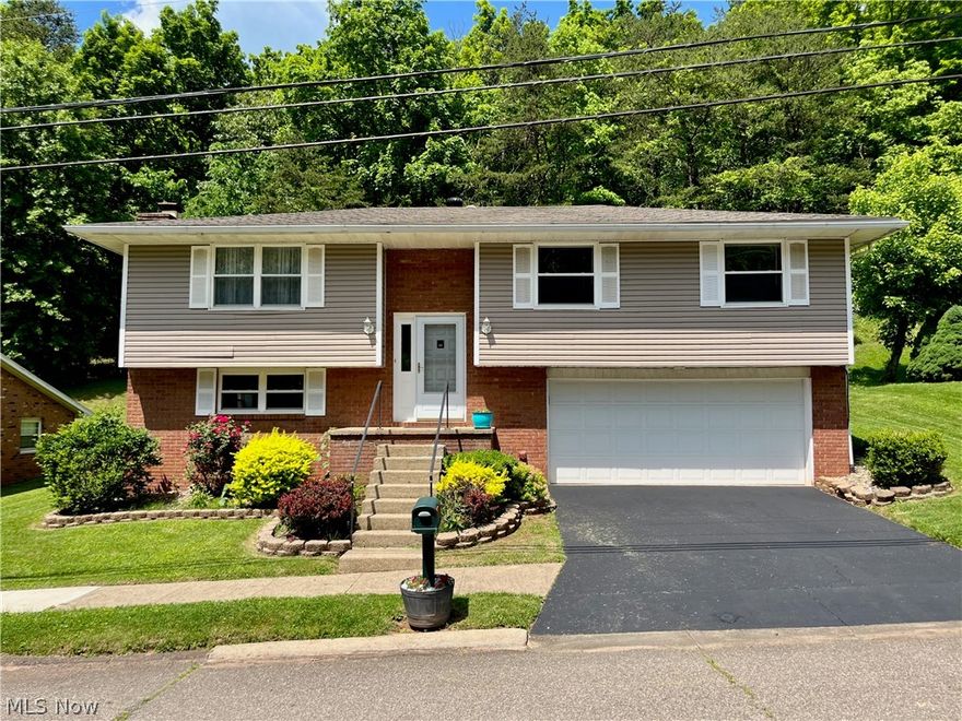 SHOWING FOR BACK-UP OFFERS!  Escape to your own exclusive paradise in Lubeck?! It's possible with this charming home featuring a deck overlooking the fenced outdoor lounge area.  Check out the stamped concrete cabana pad, with tie downs and electric,  plus another concrete pad with electric hookup for a hot tub. Easy care living inside and out with brick all around, updated LVT floors throughout.  Cozy up by the gas log fireplace in the family room, or host overnight guests: it has a door and half bath. Sellers are installing a new furnace 6/13/24, giving a 1 year America's Preferred Home Warranty to the buyer at closing and offering up to $5,000 in concessions toward buyers closing costs, fees and pre-paid items. Don't miss out on this retreat!