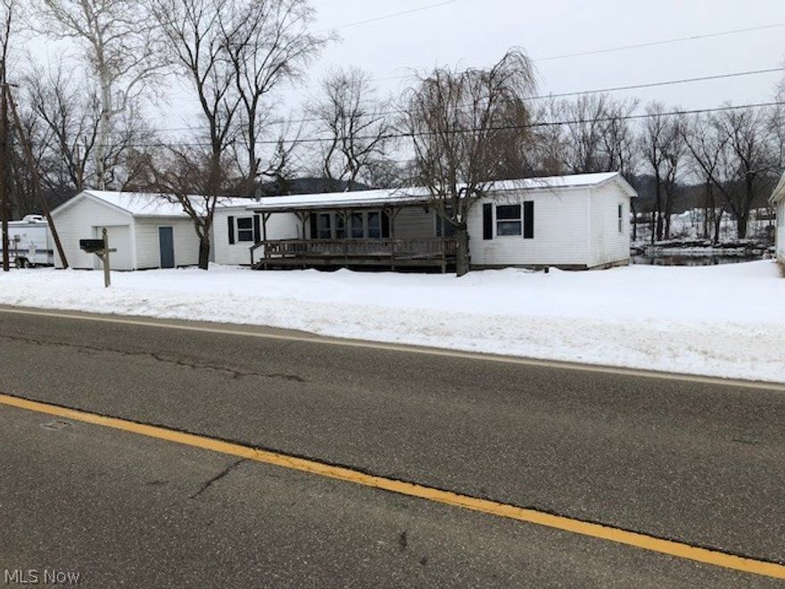 Awesome location. Water front home. Get your Kayaks and canoes ready! Nice double wide on a foundation with newer windows and doors. All new floor covering, paint, some new stainless steel countertops and 3 bedrooms 2 baths. Nice finished 20x45 garage. Property fronts the Tuscarawas River.