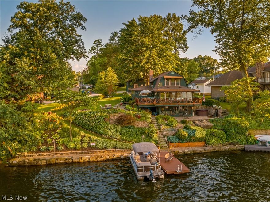 Restored century cottage, positioned uniquely on West Reservoir, main chain of Portage Lakes. This open floor plan allows magnificent 360 degree water views. Home features 3 bedrooms, 2 full baths, approximately 2,000 sq ft including walk-out lower level. Screened 20x8 lakeside porch, wood and slate floors compliment this home throughout. Fully applianced, kitchen leads to expansive sunroom offering two sliders delivering deck and balcony overlooking waterside. Master bedroom boasts cottage charm and lake feel like no other waterfront home. The main level includes fireplace, mudroom entry and walk around deck. Second level bedrooms share a bathroom and claw tub maintaining cottage atmosphere. Spiral stair delivers 9x18 rec room/wet bar onto lakeside patio. The exterior landscaping is extraordinary- starting with 115’ of waterfront barnstone seawall installed 2016 plus new Trex boat dock 20x8, stamped patio next to your personal waterfall and Jacuzzi awaits the evening stars. The adjoin