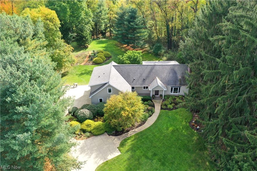 Welcome home to 659 Lois Dr, situated on 1.3+ acres of a park-like setting in the Revere School District! This gorgeous home has blended charm and modern upgrades, with elegance and warmth. From the entry you are greeted by an open living room centered by a large bay window and brick fireplace. The formal dining room leads into the large eat-in kitchen, which has been totally redone with quartz countertops, stainless steel appliances and a large kitchen island. The eat-in area of the kitchen is surrounded by windows that overlook the unbelievable, private back yard. There is a potential first floor bedroom floor with its own private deck--perfect for having your morning coffee or reading a book. The large, first floor laundry room is near the second staircase. Upstairs are four additional oversized bedrooms, including the incredible owner's suite with a luxurious full bathroom--heated tile floors, dual vanity, tiled shower and large jetted soaking tub. The lower level is partially finished, including a full bathroom for the ultimate guest space or recreation room. The 3.5 car garage has been meticulously maintained and has Amish-built cabinetry throughout. There is absolutely nothing to do in this home except to enjoy the private setting, exquisite gardens with private pathways and close proximity to everything that the Bath area has to offer. Too many updates to list- extensive list of updates is in the supplements! Call TODAY for your private showing.