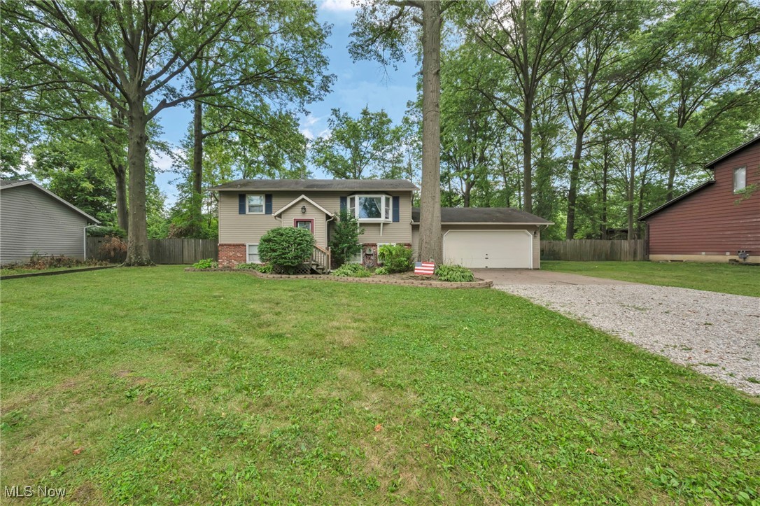Welcome home to 47655 Cooper Foster Park Rd – a true Amherst gem! This meticulously updated bi-level residence offers the perfect blend of modern style and comfortable living on a sprawling, nearly half-acre lot. As you enter, you'll be greeted by a freshly painted interior and an inspiring renovated kitchen, boasting beautiful cherry cabinetry, luxurious vinyl flooring, sleek countertops, and modern fixtures, ready for your culinary adventures. The expansive floor plan provides ample space for everyone, featuring both a formal living room and a cozy family room. An additional versatile room, perfect for a home office, playroom, or creative studio, adds to the home's functionality. Retreat to your private master suite, a true sanctuary complete with a full en-suite bathroom and a generous walk-in closet. Secondary bedrooms are thoughtfully located on a separate level for added privacy. Outside, the possibilities are endless; enjoy summer evenings on your newly painted deck, overlooking the fully fenced backyard – a safe haven for pets and play, and shaded by mature trees. The attached two-car garage provides convenient parking and storage. Located on desirable Cooper Foster Park Road, this home offers easy access to Amherst's best shopping, dining, and healthcare facilities, with quick connections to Route 2 for effortless commuting. This isn't just a house; it's a move-in ready lifestyle waiting for you!