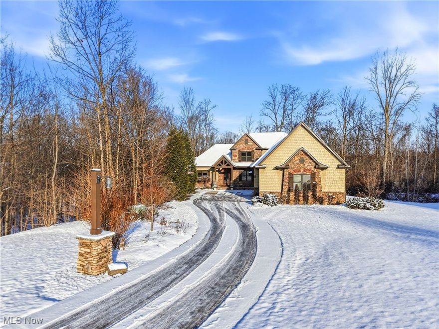 Set back 275 feet from the road, this Aspen-inspired modern Craftsman offers 5 bedrooms, 4.5 baths, and over 5,000 sq ft of thoughtfully designed living space filled with updates, conveniences—incl. an elevator—and light-filled, open interiors. A winding concrete driveway accented w stone & wood lampposts leads to a welcoming covered, beamed front porch & oversized 4-car garage. Upon entering through the one-of-a-kind wood-and-glass front door, the impressive scale of the home is apparent in the expansive foyer. The stunning great room showcases coffered ceiling, stone FP, HW floor & wall of windows overlooking wooded backyard. The eat-in kitchen has a large island, wood cabinetry, prep island, tile backsplash, pot filler, gas range w vented hood, dbl ovens, 2 Bosch dishwashers, oversized fridge/freezer & generous walk-in pantry. Surrounded by windows, the dining rm opens via slider to a composite covered deck w dramatic vaulted wood ceiling. The laundry rm feat. Amish-made cabs, granite counters w sink & access to the elevator connecting the 1st & 2nd floors (installed by Handel & Sons ’18). 1st floor primary suite feat. HW floor & access to rear patio. The en-suite bath incl. granite-topped vanity, Bain soaking tub w heated back & app-controlled bubbles, dedicated tankless HWT ’21, WC, oversized tiled walk-in shower w dual shower heads & walk-in closet w granite-topped island. Upstairs find 3 spacious BRs—1 w an en-suite BA & 2 sharing a Jack & Jill BA w 2nd laundry. The elevator opens to an unfinished 23x46 bonus space ideal for a teen suite/home gym. The finished walkout lower level ’20 feat. plush carpeting, office, rec room w access to concrete patio, a spacious BR & full BA w custom tile walk-in shower & marble-topped vanity. Home gym w Swiss Trax wood-look flr, recessed speakers & built-ins & whole-house Sonos system. Front/back sprinklers. Functional & ideal for multigenerational living, this exceptional home is minutes from 77, 21 & 271. Revere schools.