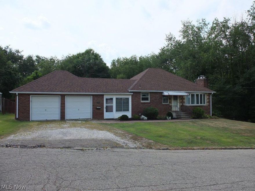 All brick 3 bedroom, 1 full bath home with walkout lower level and 2 car garage on over half acre, very private lot! Living room with picture window and fireplace. Fully applianced, eat in kitchen with oven, range, refrigerator and dishwasher. Enclosed breezeway connects the main house to the 2 car garage. Updates include new carpet, fresh paint, vinyl windows, newer roof, newer furnace and much more! Tons of extras including hardwood floors underneath the carpet, glazed tile basement, glass block basement windows, 2nd fireplace in walkout lower level, 2 car attached garage and central air...to name a few! Fantastic and huge backyard is fully fenced and backs up to woods, very private. Great location on cul-de-sac street next to a park. Put this home on your must see list!