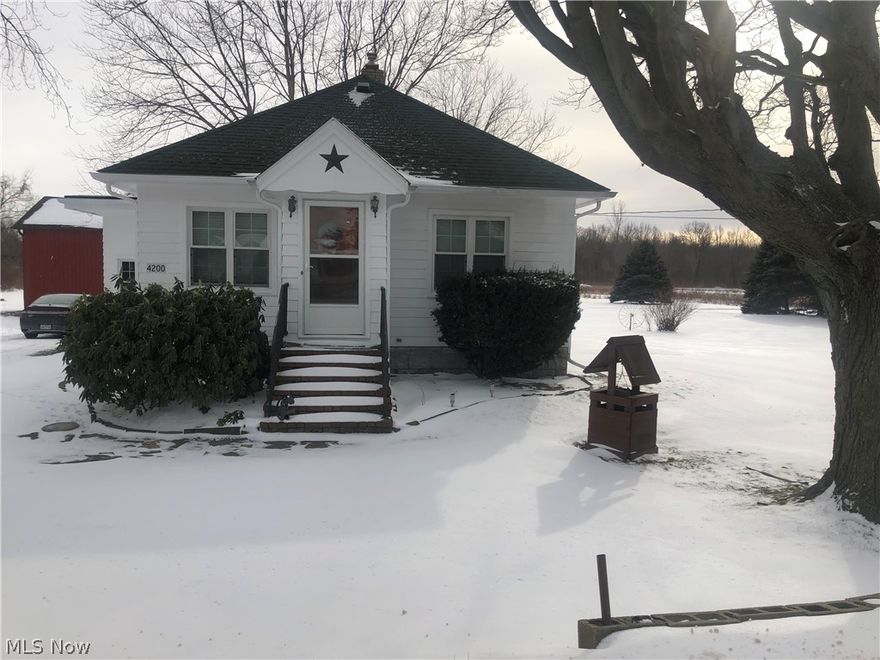 Ranch home on 5..83 acres in North Kingsville Village, with three bedrooms, one bath, Wood floors.This home has one Detached garage 24x36,Pole Building 24x34, Flat Barn 24x36 and a 12x20 Shed , they have overhead high overhead doors.There is  an extra building that was used for a fruit stand, with electric and water available in the barns.The basement is spacious  which has been waterproofed, which could be use as additional living area on one side. Home Warranty included