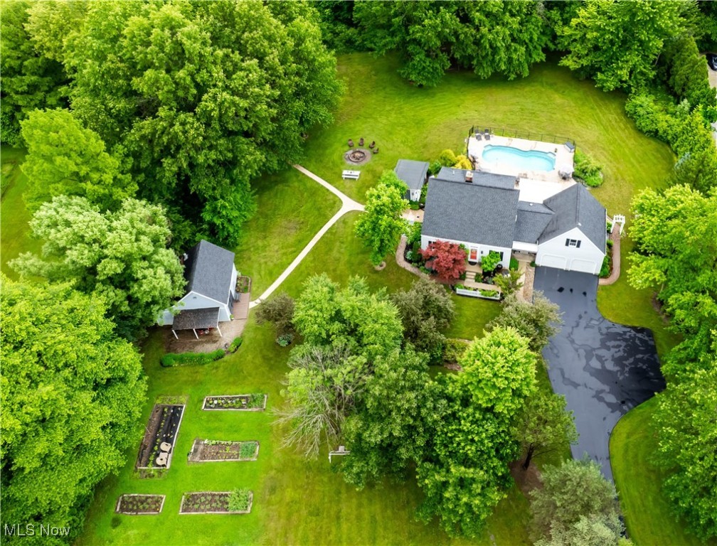 Are you looking for your dream home in the country? Do you want to homestead in style? THIS IS IT! Welcome to "Brush Creek," a nature lover's paradise on a private 5.06 acre lot. As you wind down the long paved driveway, you are greeted by a variety of fruit trees, berry bushes, beautiful flowers and a large vegetable and herb garden. The backyard is an oasis of natural beauty and a stunning array of trees, bushes and flowers lovingly planted over the years. This turnkey, picturesque property is a perfect place for entertaining with a fabulous heated and lighted pool (5 yrs), a luxurious hot tub (2 yrs) and stamped concrete deck with motorized awning for shade. Beyond the fenced in pool is lush landscaping, a serene koi fountain pond, a large lawn with a swingset, a pergola covered grilling area, and even a zipline! This amazing property is surrounded by private woods with trails, a tree fort and an area to shoot, all reached by a covered bridge over the creek. There are 4 outbuildings, including an incredible workshop, 2 smaller animal barns/sheds and a pool shed. The owners have raised chickens, bunnies, kittens bees etc. and will leave all coops and cages. This 4 bed/4 bath house is a perfect mix of country charm and stylish, updated features. The open kitchen has a large island with granite countertops, wooden beams and cabinets, large windows and a working fireplace with a stainless steel chimney liner and a cast iron wood burning stove.The kitchen leads to a cheerful dining rm with built in seating around the table. The main floor also includes a spacious living rm, a 4 seasons rm leading to the pool deck, a large mudrm, 1st floor laundry and 1/2 bath. The 2nd floor has new carpeting, an inviting master bedrm and attached bath, 2 other bedrms and a full bath. The finished, walk out basement adds another large bedrm with attached full bath, and a rec area. This kind of property does not come along often. Don't miss this chance to make Brushcreek your home.
